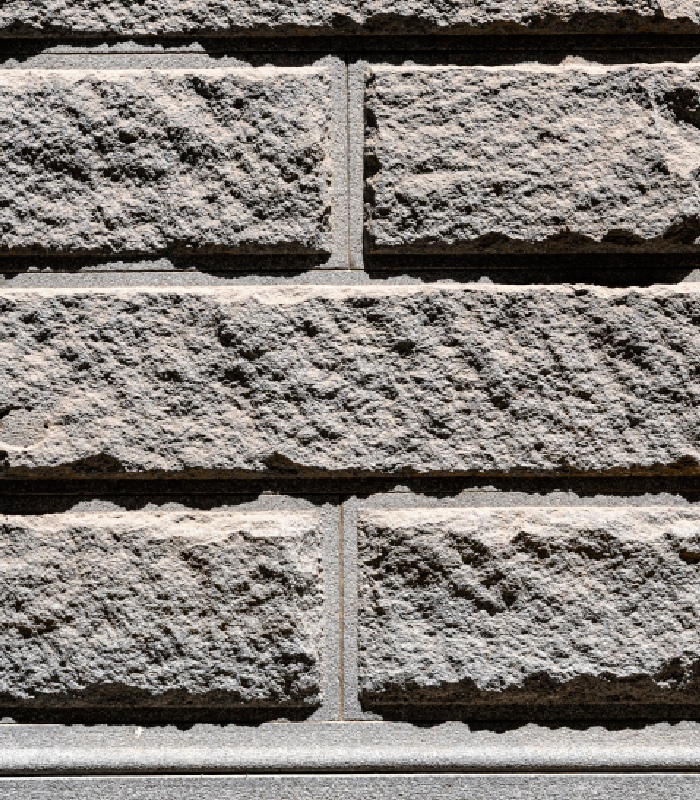 Mur en pierre taillée avec joints apparents et texture minérale